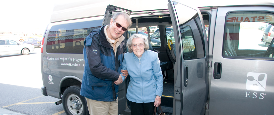 Driver assisting senior out of van